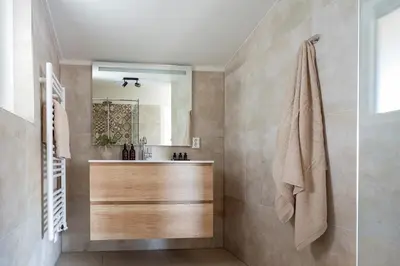 a bathroom with a sink and a mirror at Hip in Sint Maarten by Droomvilla in Sint Maarten