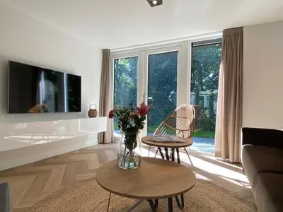 a living room with a vase of flowers on a table at Hip in Sint Maarten by Droomvilla in Sint Maarten