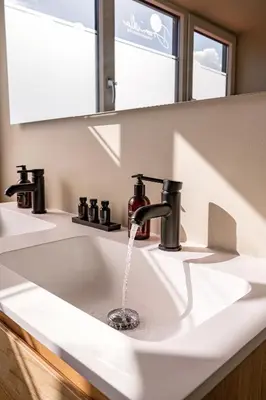 a bathroom sink with water running from a faucet at Ultiem genieten in Sint Maarten by Droomvilla in Sint Maarten