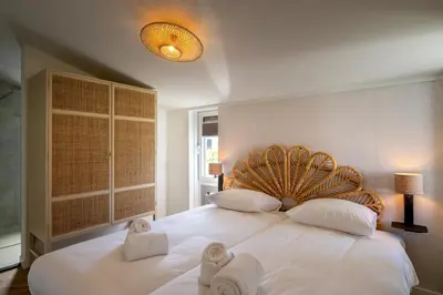 a bedroom with a large white bed with towels on it at Ultiem genieten in Sint Maarten by Droomvilla in Sint Maarten