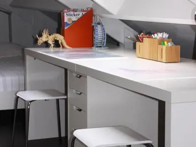 a kitchen with a white counter with two stools at Riverside holiday home near Amsterdam in Nigtevecht