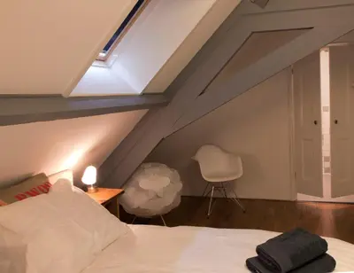 a attic bedroom with a bed and a skylight at Bed & Breakfast De Ruige Weide in Oudewater