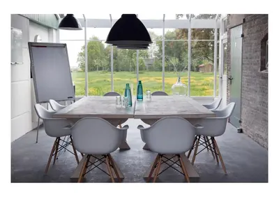 a dining room with a table and white chairs at Bed & Breakfast De Ruige Weide in Oudewater