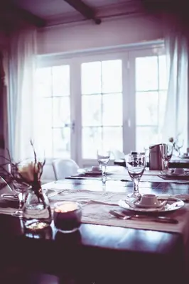 a table with glasses on it with a window at Bed & Breakfast De Ruige Weide in Oudewater