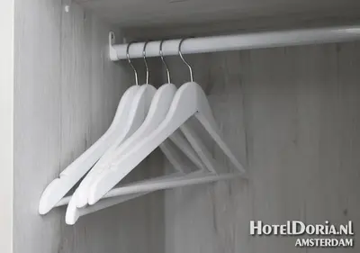 a group of white utensils hanging from a rack at Hotel Doria in Amsterdam