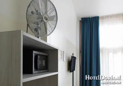 a room with a fan in a room at Hotel Doria in Amsterdam