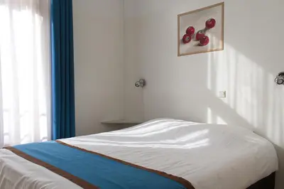 a bedroom with a bed with red apples on the wall at Hotel Doria in Amsterdam