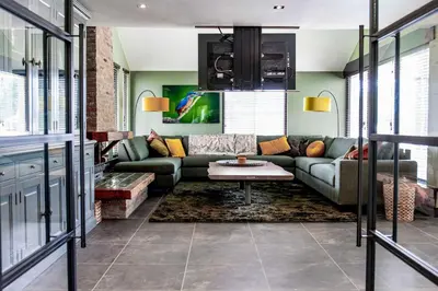 a living room with a couch and a table at Villa aan 't Wiel op Recreatiepark De Wielen in Sint Maarten