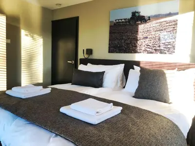 a bedroom with two beds with towels on them at Villa aan 't Wiel op Recreatiepark De Wielen in Sint Maarten