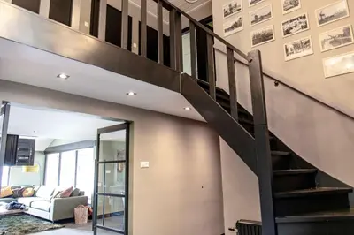 a staircase in a house with a living room at Villa aan 't Wiel op Recreatiepark De Wielen in Sint Maarten