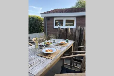 a wooden table on a patio with food on it at Country house between Egmond aan Zee & Amsterdam in Castricum