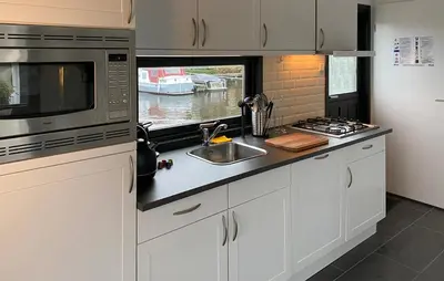 a kitchen with a sink and a microwave at 2 Bedroom Lovely Home In Breukelen in Breukelen