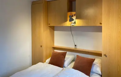 a bedroom with a bed with two pillows and a cabinet at 2 Bedroom Lovely Home In Breukelen in Breukelen