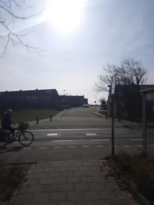 a person riding a bike down a street at Huize Visser in Egmond aan Zee