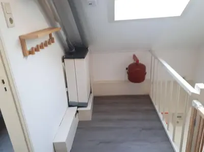 a stairway with a pot sitting on top of it at Huize Visser in Egmond aan Zee