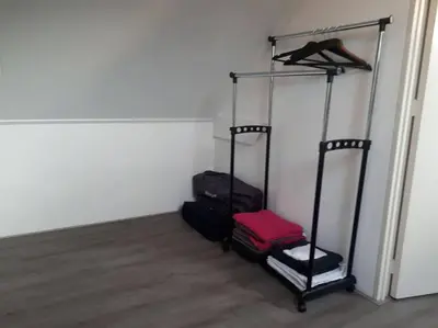 a room with two luggage racks in a room at Huize Visser in Egmond aan Zee