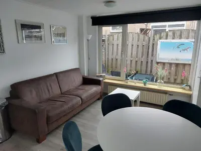 a living room with a couch and a table at Huize Visser in Egmond aan Zee