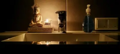 a buddha statue sitting on a shelf with a candle at Inntermezzo in Almere