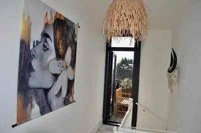 a room with a large painting of a woman on the wall at Oranje Nassau aan Zee Appartement in Zandvoort