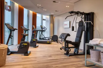 a gym with treadmills and exercise bikes in a room at IntercityHotel Amsterdam Schiphol Airport in Hoofddorp