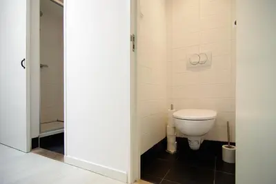 a bathroom with a toilet and a shower at Cosy apartment right in the city center with AIRCO! in Amsterdam