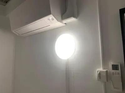 a light on a wall with a light on the ceiling at Cosy apartment right in the city center with AIRCO! in Amsterdam