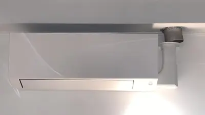 a white microwave oven hanging from a ceiling at Cosy apartment right in the city center with AIRCO! in Amsterdam