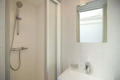 a bathroom with a shower and a sink at Cosy apartment right in the city center with AIRCO! in Amsterdam
