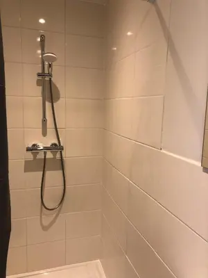 a bathroom with a shower with a shower head at Thomasloft in Oegstgeest