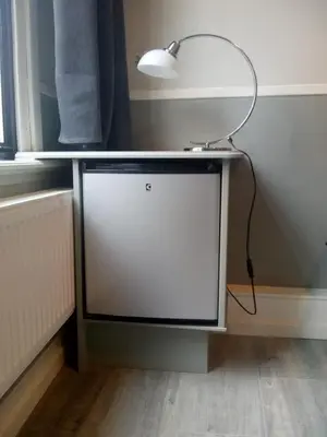 a table with a lamp on top of it at ALDO, not for parties, not a hotel, room with shared bathroom, no kitchen in Amsterdam
