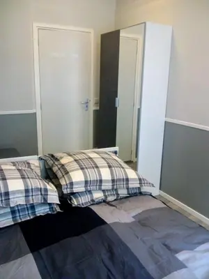 a bedroom with two beds and a mirror at ALDO, not for parties, not a hotel, room with shared bathroom, no kitchen in Amsterdam