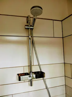 a shower light hanging from the ceiling in a bathroom at ALDO, not for parties, not a hotel, room with shared bathroom, no kitchen in Amsterdam