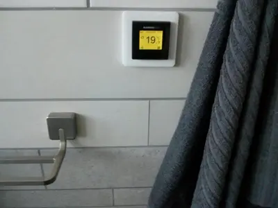 a clock on a wall in a bathroom at ALDO, not for parties, not a hotel, room with shared bathroom, no kitchen in Amsterdam
