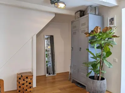 a hallway with a plant in a vase next to a door at LaneStay DamSquare in Amsterdam