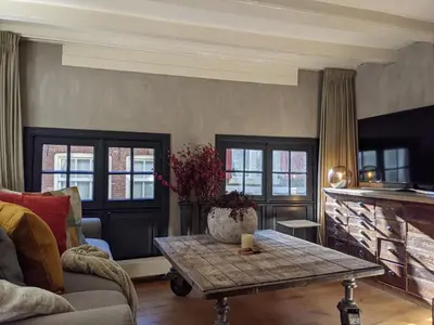 a living room with a couch and a table at LaneStay DamSquare in Amsterdam