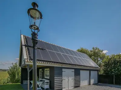 a house with solar panels on it with a street light at Spacious Holiday home De Pauwenhof in Heiloo