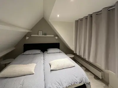 a bedroom with a bed with two pillows on it at Appelbloesem in Bergen