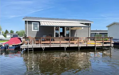 a house on a dock on a body of water at Gorgeous Home In Breukelen With Wifi in Breukelen