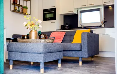 a living room with a blue couch and a table at Gorgeous Home In Breukelen With Wifi in Breukelen