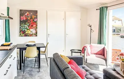 a kitchen and living room with a couch and a table at Gorgeous Home In Breukelen With Wifi in Breukelen