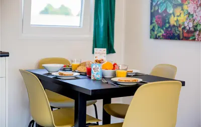 a dining room table with chairs and food on it at Gorgeous Home In Breukelen With Wifi in Breukelen