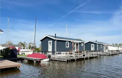 a row of houses on a dock on a body of water at Gorgeous Home In Breukelen With Wifi in Breukelen
