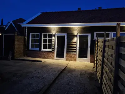 a house at night with the lights on at De Rokerij in Monnickendam