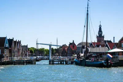 a boat is docked at a dock in the water at De Rokerij in Monnickendam