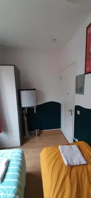 a bedroom with a bed and a room with avertisement at MICHELLE, not for parties, not a hotel, room with shared bathroom, no kitchen in Amsterdam