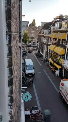 a view of a city street with a van parked on the street at MICHELLE, not for parties, not a hotel, room with shared bathroom, no kitchen in Amsterdam