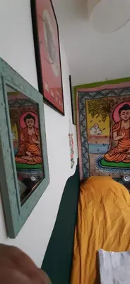 a bedroom with a bed with paintings on the wall at MICHELLE, not for parties, not a hotel, room with shared bathroom, no kitchen in Amsterdam