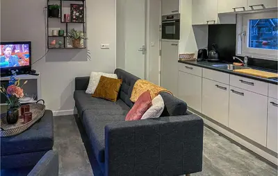 a living room with a couch and a kitchen at 2 Bedroom Awesome Home In Breukelen in Breukelen