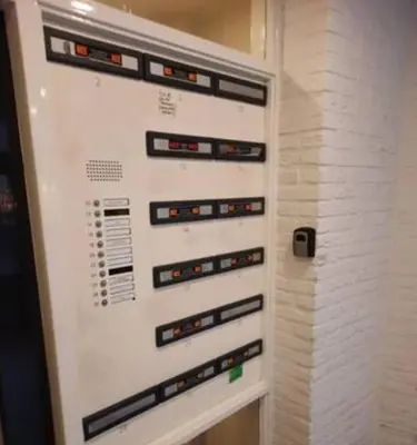 a white wall with switches and buttons on it at Have a nice stay! - Apartment Duinvos 150m from the beach in Noordwijk aan Zee