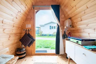 a kitchen with a window in a tiny house at Tiny Camping Pod in Warmond